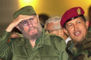 Cuban President Fidel Castro, left, and Venezuelan President Hugo Chavez watch students during a meeting at Barquisimeto University, 217 miles (350 kilometers) west of Caracas, Venezuela, Saturday, Oct. 28, 2000. With a vast country to show off, Venezuelan President Hugo Chavez could have taken Castro to see the world's highest waterfall, impressive colonial forts or stunning coral reefs. Instead, Chavez escorted the Cuban leader Saturday to his hometown of Sabaneta and other parts of western Venezuela's cowboy country. (AP Photo/Fernando Llano)